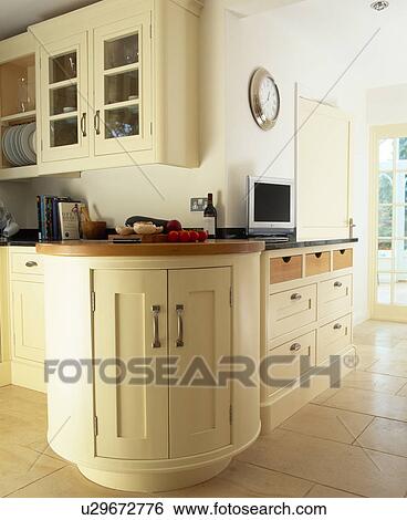 Curved fitted cupboard in large traditional cream country kitchen View Large Photo Image Stock Photograph - Curved fitted cupboard in large traditional cream country kitchen. Fotosearch