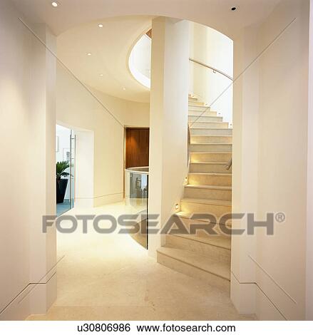 Curved wooden staircase in modern white hall View Large Photo Image Stock Photograph - Curved wooden staircase in modern white hall. Fotosearch