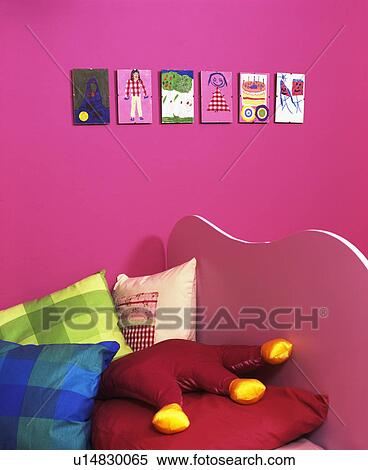 Cushions on bed in child's economy-style pink bedroom View Large Photo Image Stock Photography - Cushions on bed in child's economy-style pink bedroom. Fotosearch