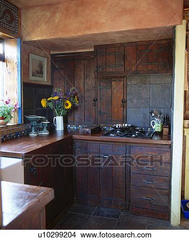 Dark wood units in country kitchen View Large Photo Image Picture - Dark wood units in country kitchen. Fotosearch