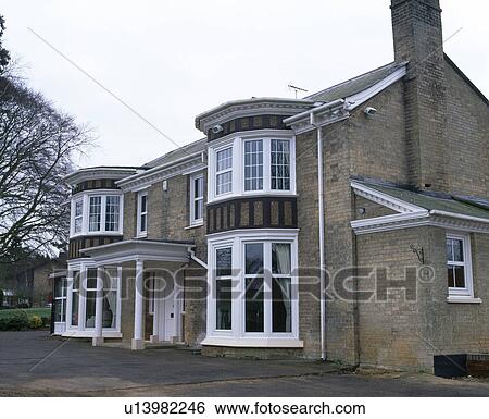 Stock Photograph - Detached Victorian country house with bay windows. Fotosearch