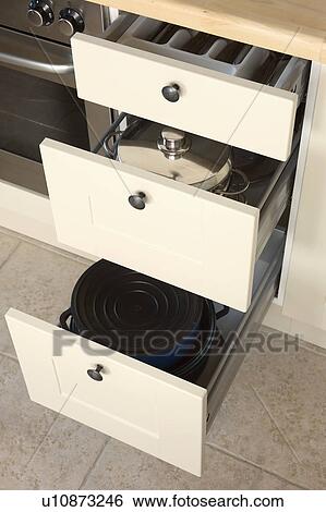 Detail of modern kitchen in stone building with neutral coloured materials and beamed ceiling. View Large Photo Image Stock Photograph - Detail of modern kitchen in stone building with neutral coloured materials and beamed ceiling.. Fotosearch