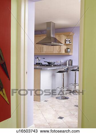 Door open to modern mauve kitchen with stools at breakfast bar View Large Photo Image Stock Image - Door open to modern mauve kitchen with stools at breakfast bar. Fotosearch