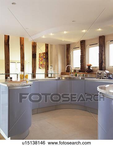 Downlighting In False Ceiling In Modern Country Kitchen With Pale Blue Fitted Units Stock Photograph