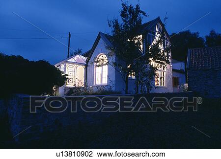Eighties house with extension and apex roof lit at night View Large Photo Image Stock Image - Eighties house with extension and apex roof lit at night. Fotosearch