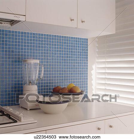 Electric blender on white worktop below turquoise wall tiles View Large Photo Image Stock Image - Electric blender on white worktop below turquoise wall tiles. Fotosearch