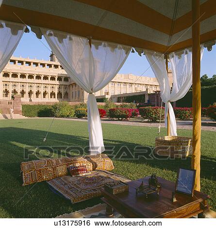 Embroidered cushions and white drapes in traditional Rajastani tent on lawn in front of the Palace of Jodhpur View Large Photo Image Stock Photograph - Embroidered cushions and white drapes in traditional Rajastani tent on lawn in front of the Palace of Jodhpur. Fotosearch