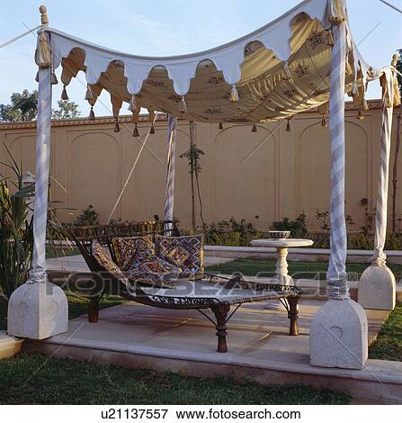 Embroidered Rajastani cushions on charpoy below tented canopy in courtyard of Rajvilas Hotel in Rajastan View Large Photo Image Stock Photo - Embroidered Rajastani cushions on charpoy below tented canopy in courtyard of Rajvilas Hotel in Rajastan. Fotosearch