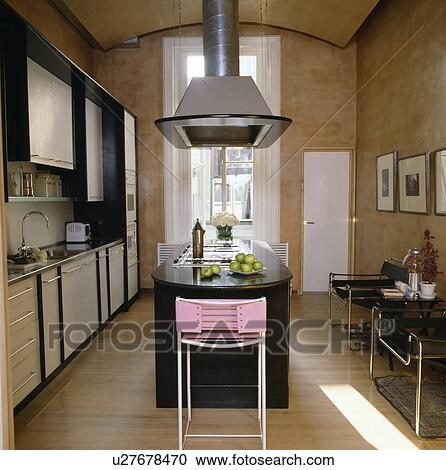 Extractor above black granite island unit in modern kitchen View Large Photo Image Stock Image - Extractor above black granite island unit in modern kitchen. Fotosearch