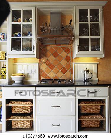 Extractor above hob in fitted unit with storage baskets View Large Photo Image Stock Photo - Extractor above hob in fitted unit with storage baskets. Fotosearch