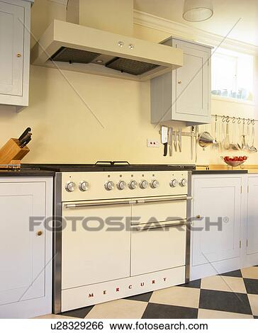 Extractor above white Mercury range oven in traditional country kitchen View Large Photo Image Stock Photograph - Extractor above white Mercury range oven in traditional country kitchen. Fotosearch