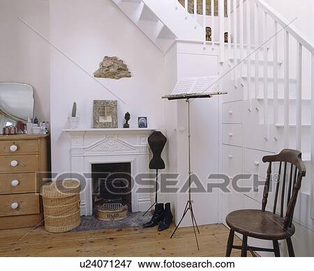 Stock Photo - Fireplace in whtie bedroom with staircase. Fotosearch