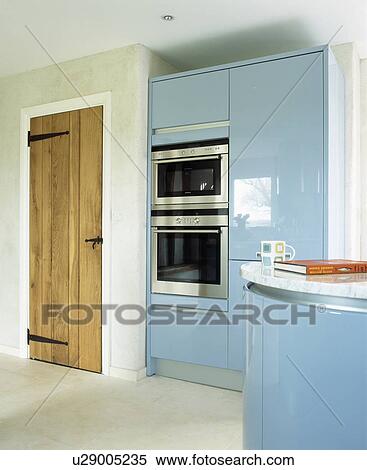 Fitted double oven in tall fitted unit in modern white kitchen with pale blue lacquered units View Large Photo Image Stock Photography - Fitted double oven in tall fitted unit in modern white kitchen with pale blue lacquered units. Fotosearch
