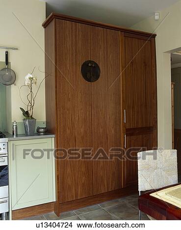 Picture - Fitted kitchen cupboard oncealing large fridge-freezer. Fotosearch