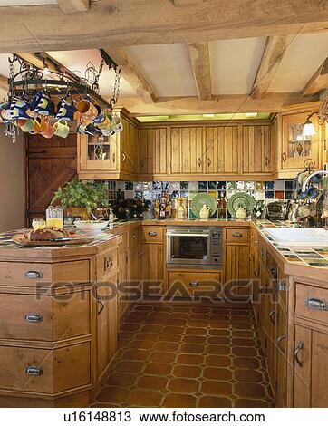 Fitted pine units in country kitchen with beamed ceiling View Large Photo Image Stock Image - Fitted pine units in country kitchen with beamed ceiling. Fotosearch