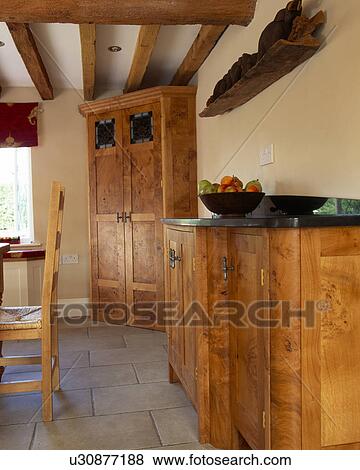 Stock Photo - Fitted pippy-oak units in country kitchen. Fotosearch