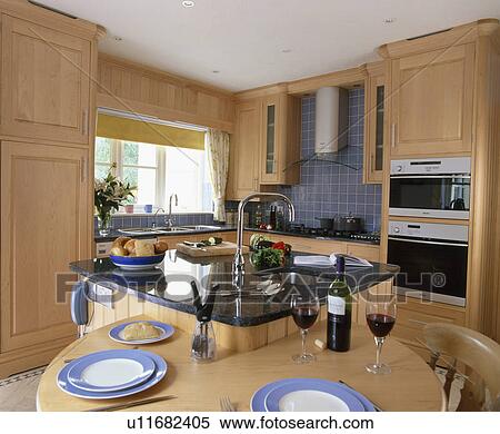 Fitted table on island unit in modern kitchen View Large Photo Image Stock Photography - Fitted table on island unit in modern kitchen. Fotosearch
