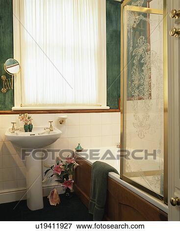 Fitted voile curtain on window in bathroom with engraved glass shower screen on bath View Large Photo Image Stock Photo - Fitted voile curtain on window in bathroom with engraved glass shower screen on bath. Fotosearch