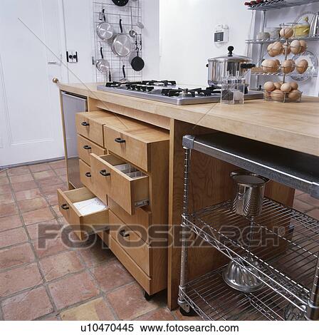 Stock Photography - Fitted woodenb storage drawers beside oven in modern kitchen. Fotosearch