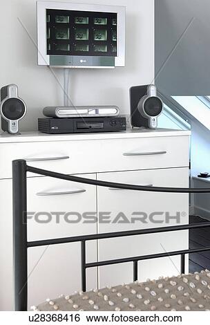 Flatscreen television and small hi-fi on white fitted cupboard in bedroom View Large Photo Image Stock Photograph - Flatscreen television and small hi-fi on white fitted cupboard in bedroom. Fotosearch