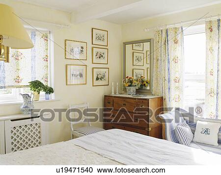 Floral blind and curtains in traditional cottage bedroom View Large Photo Image Stock Image - Floral blind and curtains in traditional cottage bedroom. Fotosearch