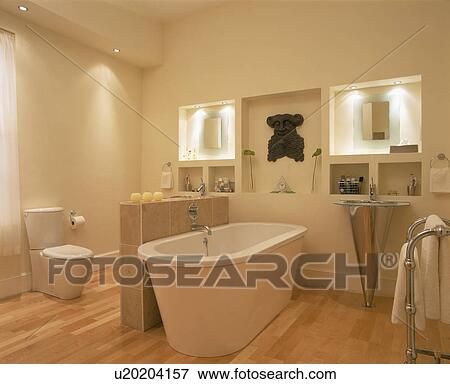 Stock Photo - Freestanding bath in modern white bathroom with stainless steel pedestal basin. Fotosearch