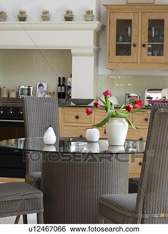 Glass And Wicker Pedestal Table With High Back Wicker Dining Chairs In Kitchen Dining Room Stock Photograph U12467066 Fotosearch