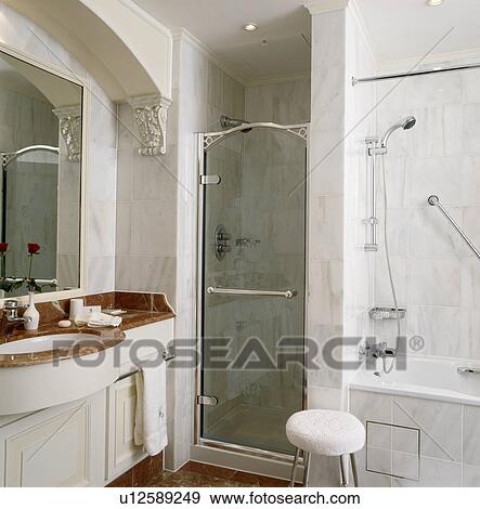 Glass door on shower in marble bathroom View Large Photo Image Stock Photo - Glass door on shower in marble bathroom. Fotosearch