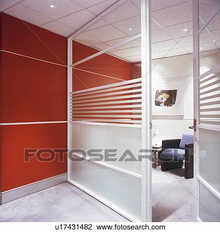 Stock Image - Glass doors in modern commercial office with red wall. Fotosearch