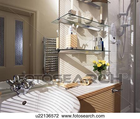 Glass shelves beside basin in modern bathroom View Large Photo Image Stock Image - Glass shelves beside basin in modern bathroom. Fotosearch