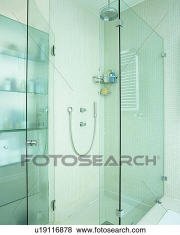 Glass shower cabinet in modern white bathroom View Large Photo Image Stock Photo - Glass shower cabinet in modern white bathroom. Fotosearch