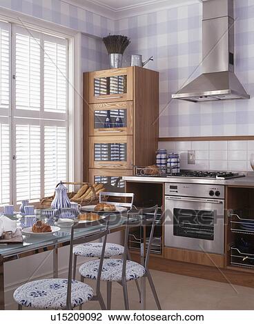 Glass-topped dining table and blue checked walls in modern kiitchen View Large Photo Image Stock Image - Glass-topped dining table and blue checked walls in modern kiitchen. Fotosearch