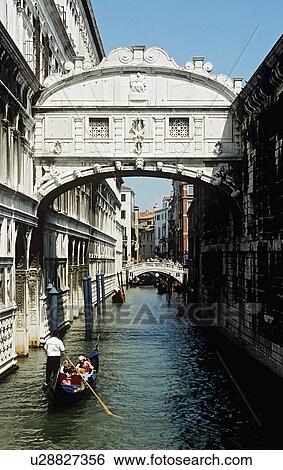 Gondola gliding on canal below the Bridge of Sighs in Venice View Large Photo Image Stock Photograph - Gondola gliding on canal below the Bridge of Sighs in Venice . Fotosearch