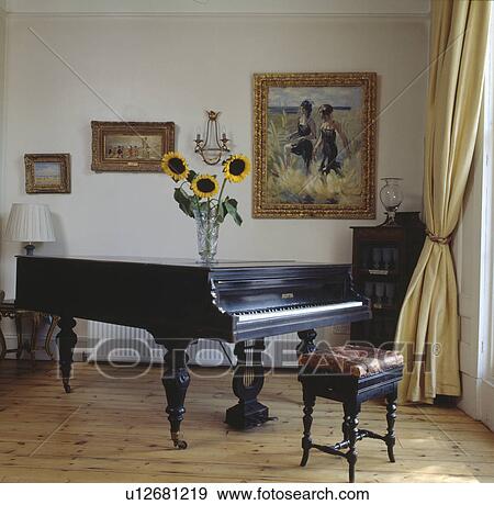 Grand piano and antique piano stool in living room with pastel yellow silk curtain and wooden flooring View Large Photo Image Stock Photo - Grand piano and antique piano stool in living room with pastel yellow silk curtain and wooden flooring. Fotosearch