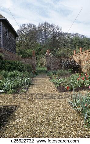 Gravel path through large formal walled country garden in Spring View Large Photo Image Stock Image - Gravel path through large formal walled country garden in Spring. Fotosearch