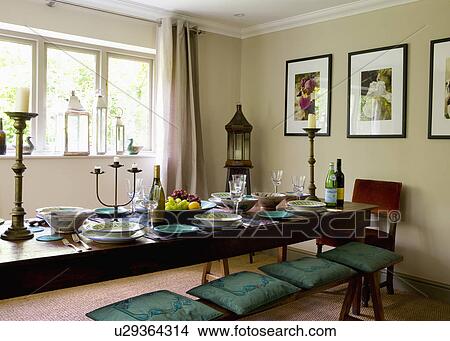 Green cushions on oak bench with oak table in neutral dining room View Large Photo Image Picture - Green cushions on oak bench with oak table in neutral dining room. Fotosearch