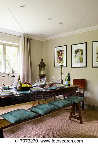 Green Cushions On Oak Bench With Oak Table In Neutral Dining Room