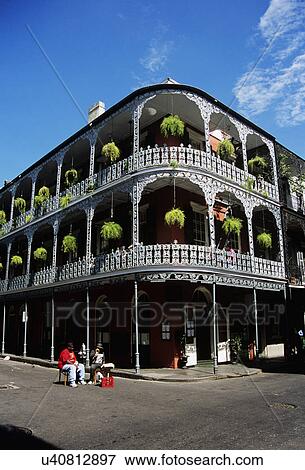Green ferns in hanging baskets above wrought iron balconies on Le Monnier house in New Orleans
 View Large Photo Image Stock Photo - Green ferns in hanging baskets above wrought iron balconies on Le Monnier house in New Orleans
. Fotosearch