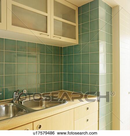 Green tiled wall above double stainless steel sink in modern kitchen View Large Photo Image Stock Photograph - Green tiled wall above double stainless steel sink in modern kitchen. Fotosearch