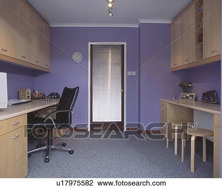 Stock Image - Grey flooring in mauve home office with fitted beech cupboards. Fotosearch