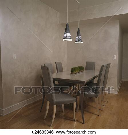 Grey silk upholstered chairs at table in grey dining room with sponge-effect walls View Large Photo Image Stock Photograph - Grey silk upholstered chairs at table in grey dining room with sponge-effect walls. Fotosearch