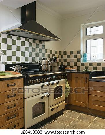 Grey White Tiles Above Cream Range Oven In Traditional Kitchen