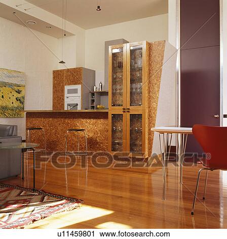 Lacquered woodchip surface on fitted units in modern kitchen with wooden flooring View Large Photo Image Stock Image - Lacquered woodchip surface on fitted units in modern kitchen with wooden flooring. Fotosearch