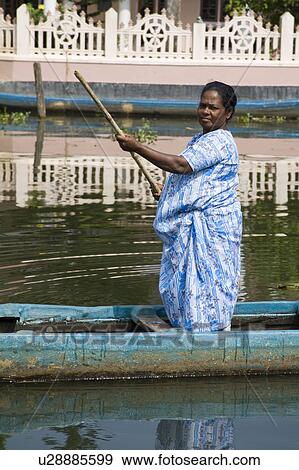 Lady punting across a river from her home, Kerala, India View Large Photo Image Stock Photo - Lady punting across a river from her home, Kerala, India. Fotosearch