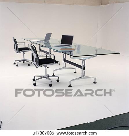 Laptop computer on glass and chrome table with black leather and chrome office chairs View Large Photo Image Stock Photography - Laptop computer on glass and chrome table with black leather and chrome office chairs. Fotosearch