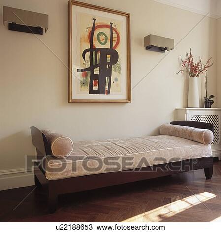 Stock Image - Large abstract picture on wall above traditional beige velvet chaiselongue. Fotosearch