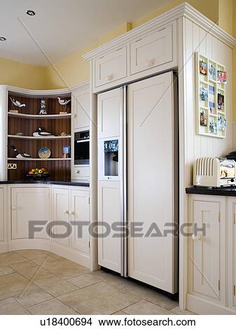 Large American-style fridge-freezer in modern cream kitchen View Large Photo Image Picture - Large American-style fridge-freezer in modern cream kitchen. Fotosearch