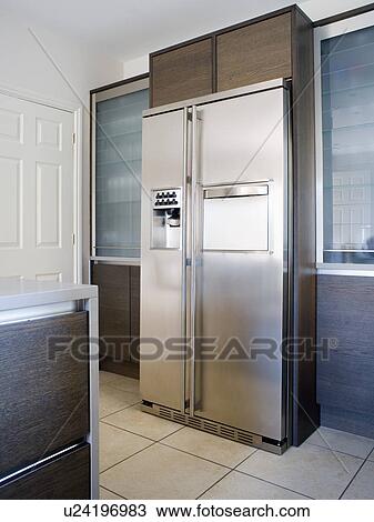 Large American-style stainless-steel fridge-freezer in modern kitchen View Large Photo Image Stock Image - Large American-style stainless-steel fridge-freezer in modern kitchen. Fotosearch