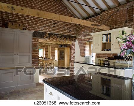 Stock Photo - Large barn conversion kitchen and dining room. Fotosearch