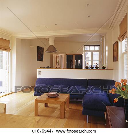 Large blue fitted sofa in modern open-plan living room View Large Photo Image Stock Photo - Large blue fitted sofa in modern open-plan living room. Fotosearch